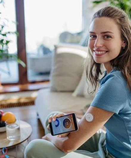 A woman reading her glucose sensor on her phone.