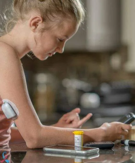 A girl checking her blood sugar beside her glucose sensor.