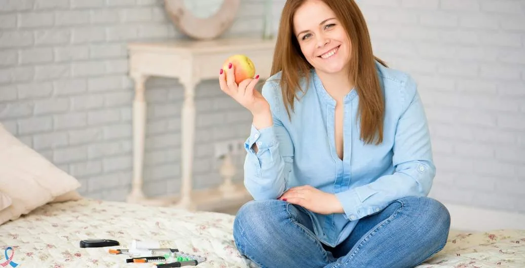A smiling woman holding an apple.