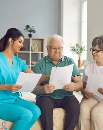 A nurse going through paperwork with two patients.