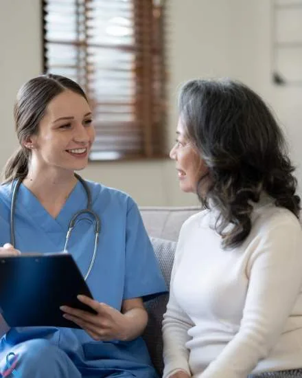A nurse talking with a patient.