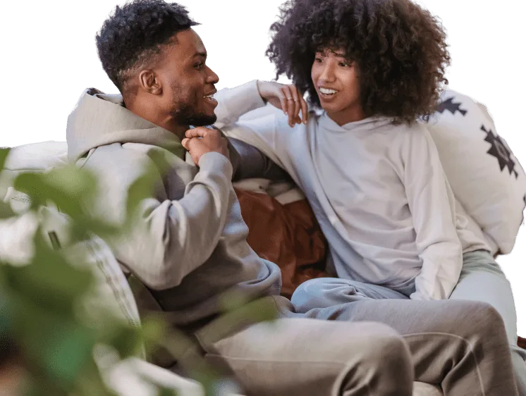 A young couple laughing together at home.