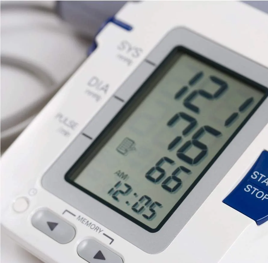 A blood pressure monitor showing a reading.